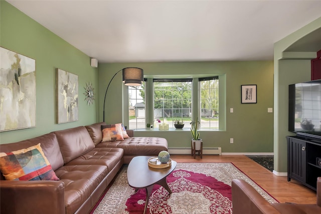 3717 Aster St, East Helena, MT 59635 - living room featuring light wood-style floors, a baseboard heating unit, and baseboards
