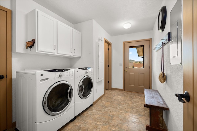 75 Windriver Dr, Kalispell, MT 59901 - laundry area featuring washing machine and clothes dryer, cabinet space, baseboards, and stone finish floors
