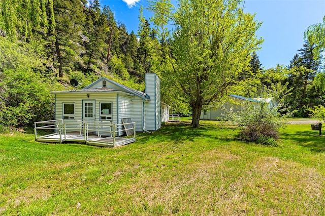 1160 US Highway 12 E, Townsend, MT 59644 - rear view of property with a lawn, a deck, and a chimney
