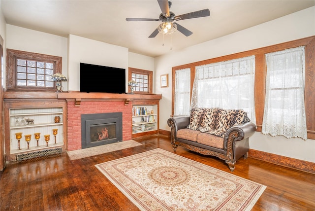 804 Broadway St, Townsend, MT 59644 - living room with wood finished floors, healthy amount of natural light, a ceiling fan, and a brick fireplace