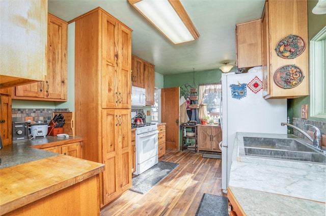 804 Broadway St, Townsend, MT 59644 - kitchen featuring white appliances, tasteful backsplash, light wood-type flooring, and wood counters