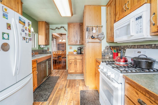 804 Broadway St, Townsend, MT 59644 - kitchen with white appliances, light wood finished floors, tasteful backsplash, and light countertops