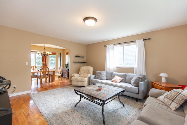 3401 Ravalli St, Bozeman, MT 59718 - living area with arched walkways, a chandelier, and light wood finished floors