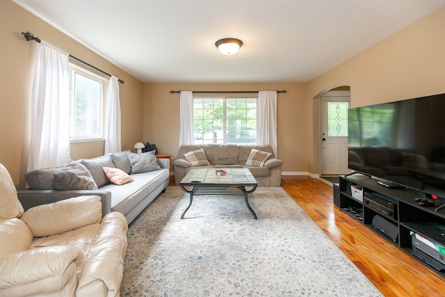 3401 Ravalli St, Bozeman, MT 59718 - living area with arched walkways, wood finished floors, and baseboards