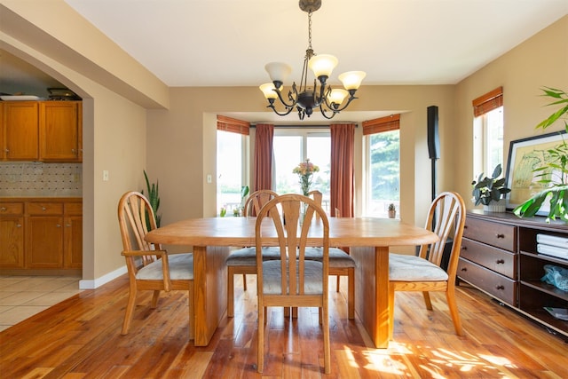 3401 Ravalli St, Bozeman, MT 59718 - dining room featuring a chandelier, light wood finished floors, and arched walkways