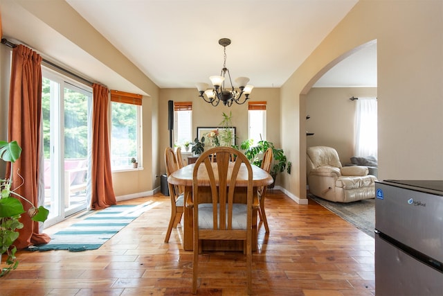 3401 Ravalli St, Bozeman, MT 59718 - dining room with a chandelier, light wood-style floors, healthy amount of natural light, and arched walkways