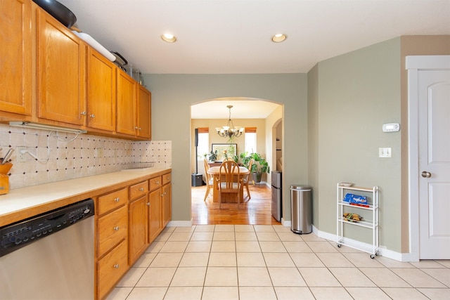 3401 Ravalli St, Bozeman, MT 59718 - kitchen featuring stainless steel dishwasher, arched walkways, backsplash, light countertops, and a chandelier