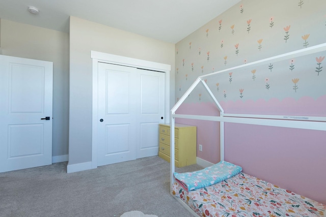 2805 Travis Ave, Helena, MT 59601 - bedroom with carpet floors, a closet, wallpapered walls, and baseboards