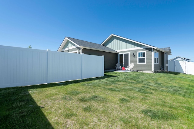 2805 Travis Ave, Helena, MT 59601 - back of property with board and batten siding and a patio area