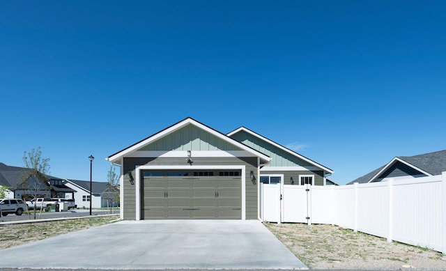 2805 Travis Ave, Helena, MT 59601 - ranch-style house with board and batten siding, a garage, and concrete driveway