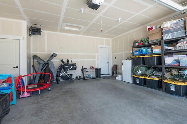 2805 Travis Ave, Helena, MT 59601 - garage with freestanding refrigerator and a garage door opener