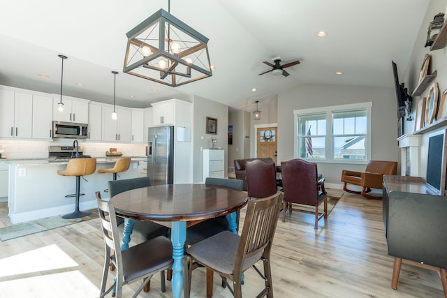 2805 Travis Ave, Helena, MT 59601 - dining area with lofted ceiling, light wood-style flooring, ceiling fan, recessed lighting, and a chandelier