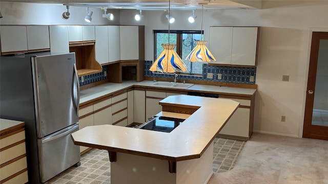 10 Pine Ridge Cir, Clancy, MT 59634 - kitchen featuring freestanding refrigerator, a sink, decorative backsplash, light countertops, and a kitchen island