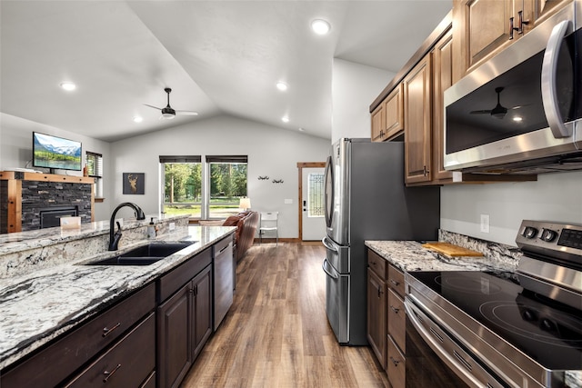 165 Lynx Ct, Seeley Lake, MT 59868 - kitchen featuring stainless steel appliances, ceiling fan, a sink, wood finished floors, and light stone countertops