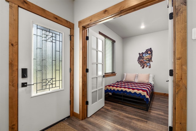 165 Lynx Ct, Seeley Lake, MT 59868 - bedroom with wood finished floors, multiple windows, and baseboards