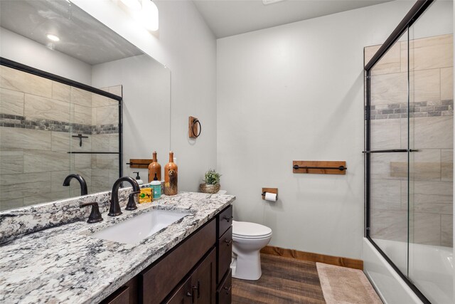 165 Lynx Ct, Seeley Lake, MT 59868 - bathroom with vanity, toilet, baseboards, and tiled shower / bath