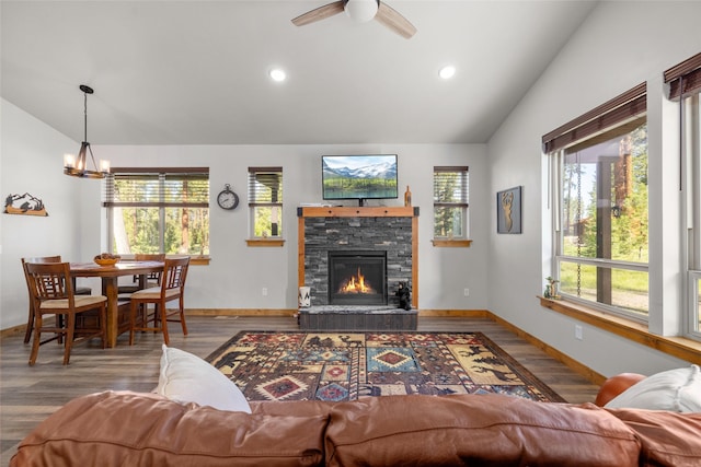 165 Lynx Ct, Seeley Lake, MT 59868 - living room featuring lofted ceiling, a fireplace, wood finished floors, a chandelier, and ceiling fan