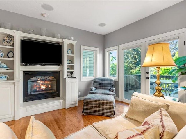 140 Fairway Dr, Missoula, MT 59803 - living area featuring plenty of natural light, a glass covered fireplace, and light wood finished floors