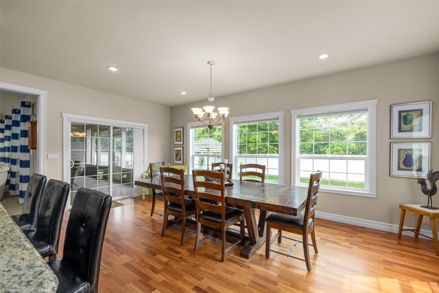 65 Glacier Cir, Kalispell, MT 59901 - dining area with light wood-style floors, a chandelier, recessed lighting, and baseboards