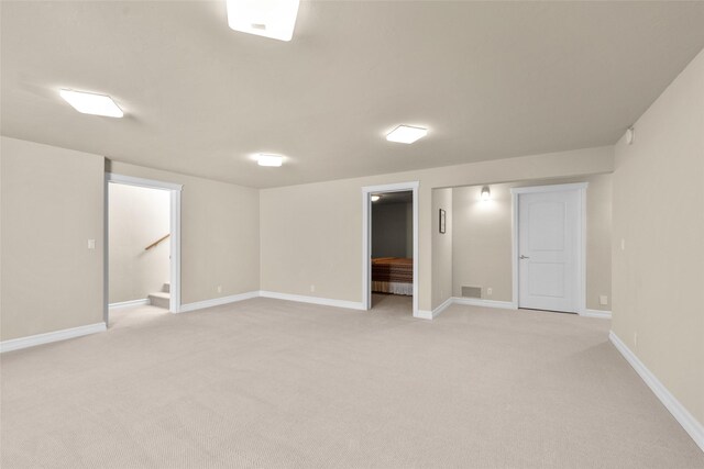 65 Glacier Cir, Kalispell, MT 59901 - finished below grade area featuring light carpet, baseboards, and stairs