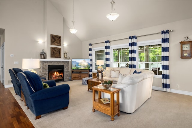 65 Glacier Cir, Kalispell, MT 59901 - living room with high vaulted ceiling, a fireplace, and baseboards