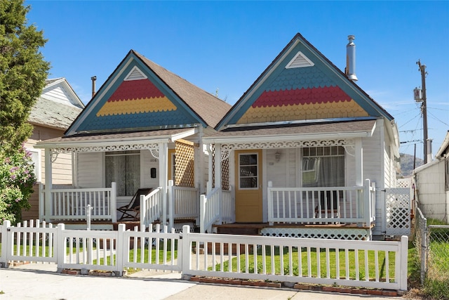 1116 California Ave, Butte, MT 59701 - victorian home featuring a porch, a fenced front yard, and a gate