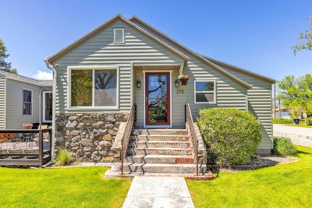 215 N Oak St, Townsend, MT 59644 - bungalow-style house with a front lawn, entry steps, and stone siding