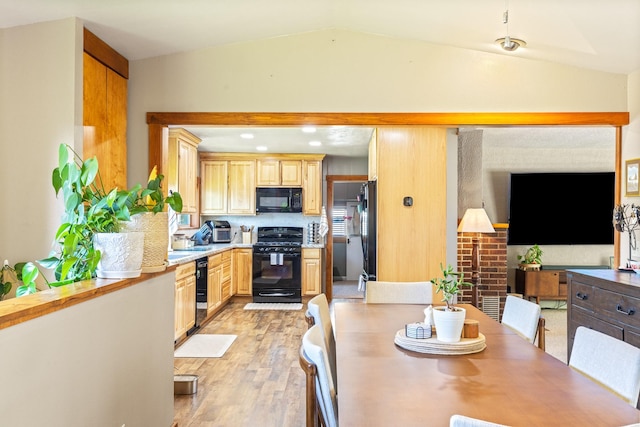 215 N Oak St, Townsend, MT 59644 - kitchen with black appliances, light brown cabinets, light wood-type flooring, light countertops, and vaulted ceiling