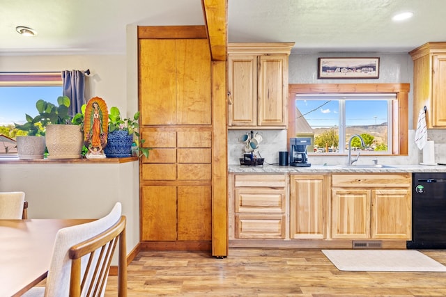 215 N Oak St, Townsend, MT 59644 - kitchen with black dishwasher, tasteful backsplash, light countertops, light wood-style flooring, and light brown cabinets