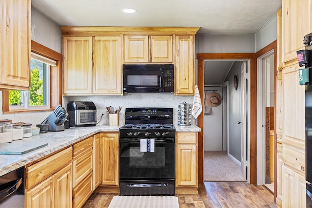 215 N Oak St, Townsend, MT 59644 - kitchen featuring black appliances, backsplash, wood finished floors, light stone countertops, and light brown cabinetry