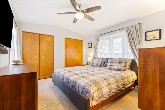 215 N Oak St, Townsend, MT 59644 - bedroom with lofted ceiling, two closets, light colored carpet, and a ceiling fan