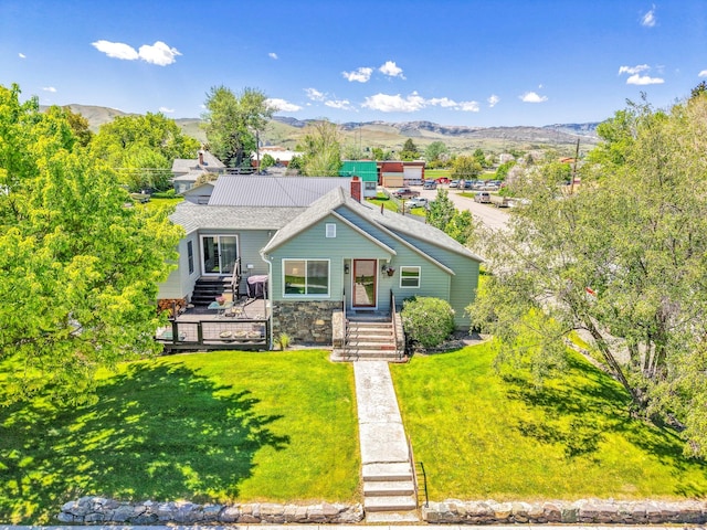 215 N Oak St, Townsend, MT 59644 - view of front of property with a front lawn, stone siding, and a mountain view
