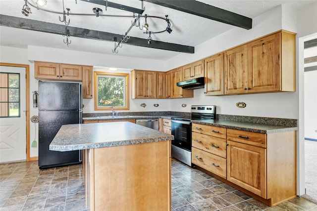 1165 Rock Creek Rd, Clinton, MT 59825 - kitchen with stainless steel appliances, under cabinet range hood, a center island, dark countertops, and beam ceiling