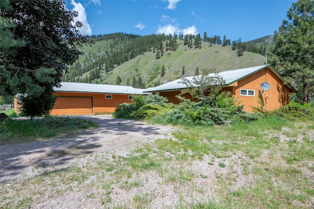 1165 Rock Creek Rd, Clinton, MT 59825 - view of front of property with a garage, gravel driveway, and an outbuilding