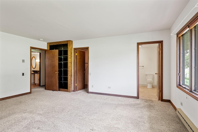 1165 Rock Creek Rd, Clinton, MT 59825 - unfurnished bedroom with a baseboard heating unit, carpet flooring, and ensuite bathroom