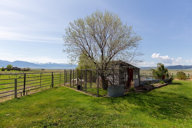 49 Redtail Hawk Rd, Mcallister, MT 59740 - view of yard featuring a mountain view, an outdoor structure, and a view of rural / pastoral area