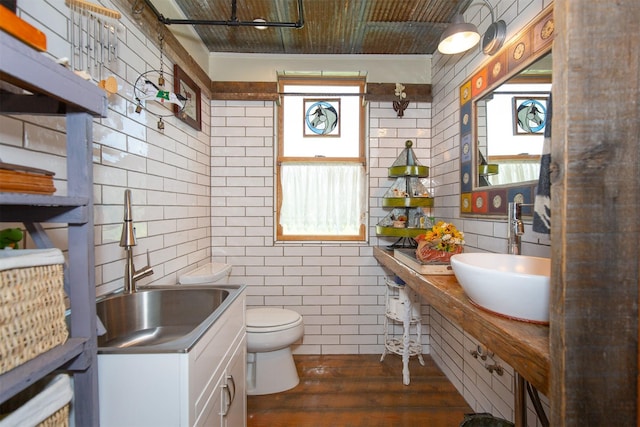 49 Redtail Hawk Rd, Mcallister, MT 59740 - bathroom with tile walls, vanity, and hardwood / wood-style flooring