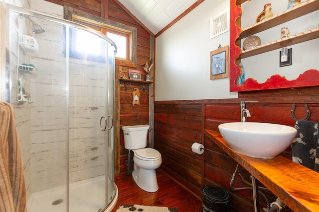 49 Redtail Hawk Rd, Mcallister, MT 59740 - bathroom featuring wood walls, vaulted ceiling, wood-type flooring, a stall shower, and vanity