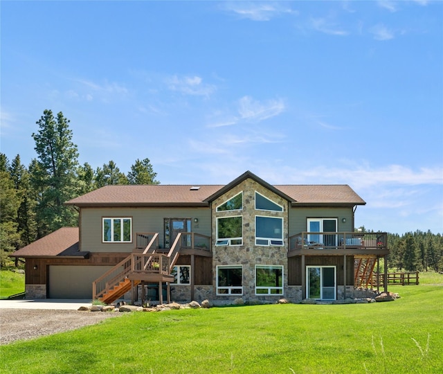 36 Lost Trl, Clancy, MT 59634 - back of house featuring stairs, stone siding, driveway, a deck, and a lawn