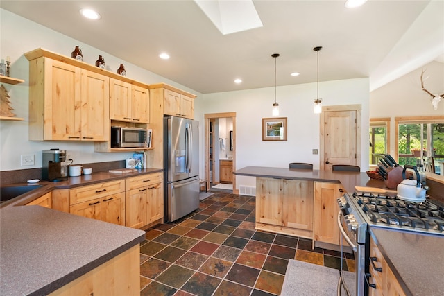 36 Lost Trl, Clancy, MT 59634 - kitchen with appliances with stainless steel finishes, light brown cabinetry, dark countertops, recessed lighting, and a skylight