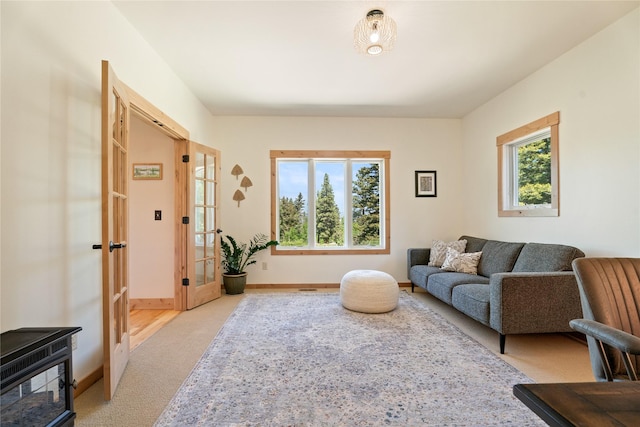 36 Lost Trl, Clancy, MT 59634 - living area featuring light colored carpet, baseboards, and french doors