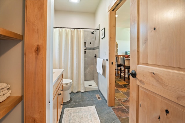 36 Lost Trl, Clancy, MT 59634 - full bath featuring vanity, tiled shower, stone finish flooring, and toilet