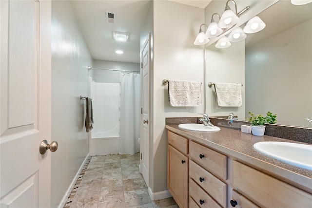 36 Lost Trl, Clancy, MT 59634 - bathroom with baseboards, double vanity, stone finish flooring, and shower / bath combo