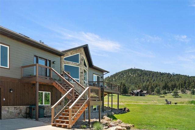 36 Lost Trl, Clancy, MT 59634 - rear view of property featuring a lawn, stairway, and a deck with mountain view