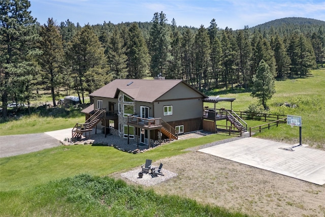 36 Lost Trl, Clancy, MT 59634 - rear view of property with stairway, a deck, a forest view, and a fire pit