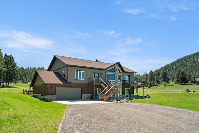 36 Lost Trl, Clancy, MT 59634 - view of front of property with stairs, driveway, a front yard, stone siding, and a deck