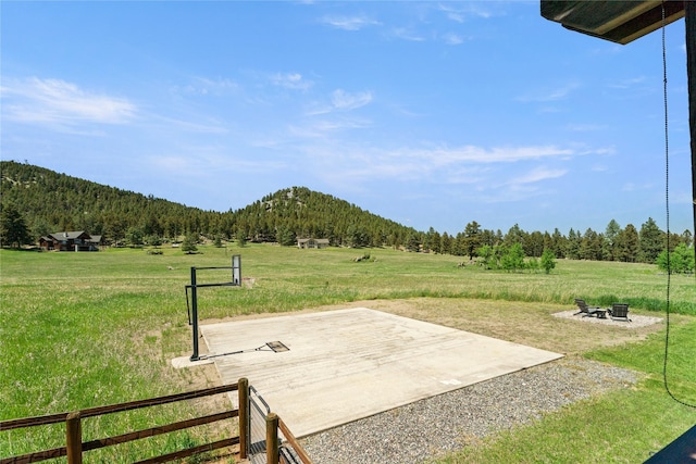 36 Lost Trl, Clancy, MT 59634 - view of patio featuring a wooded view, a fire pit, and a mountain view