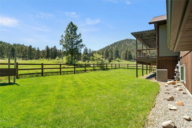36 Lost Trl, Clancy, MT 59634 - view of yard with central AC, a deck with mountain view, a view of trees, and a rural view