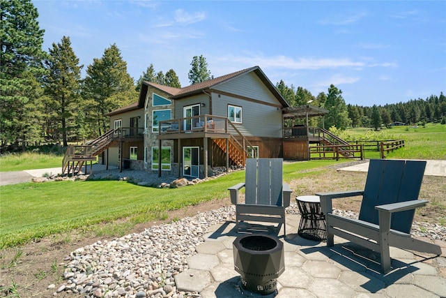36 Lost Trl, Clancy, MT 59634 - back of house featuring stairs, a deck, a yard, a patio area, and a forest view