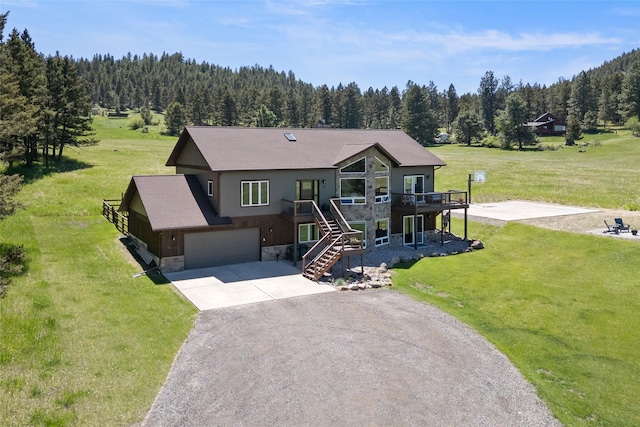 36 Lost Trl, Clancy, MT 59634 - view of front of home featuring stone siding, a wooded view, stairs, and concrete driveway